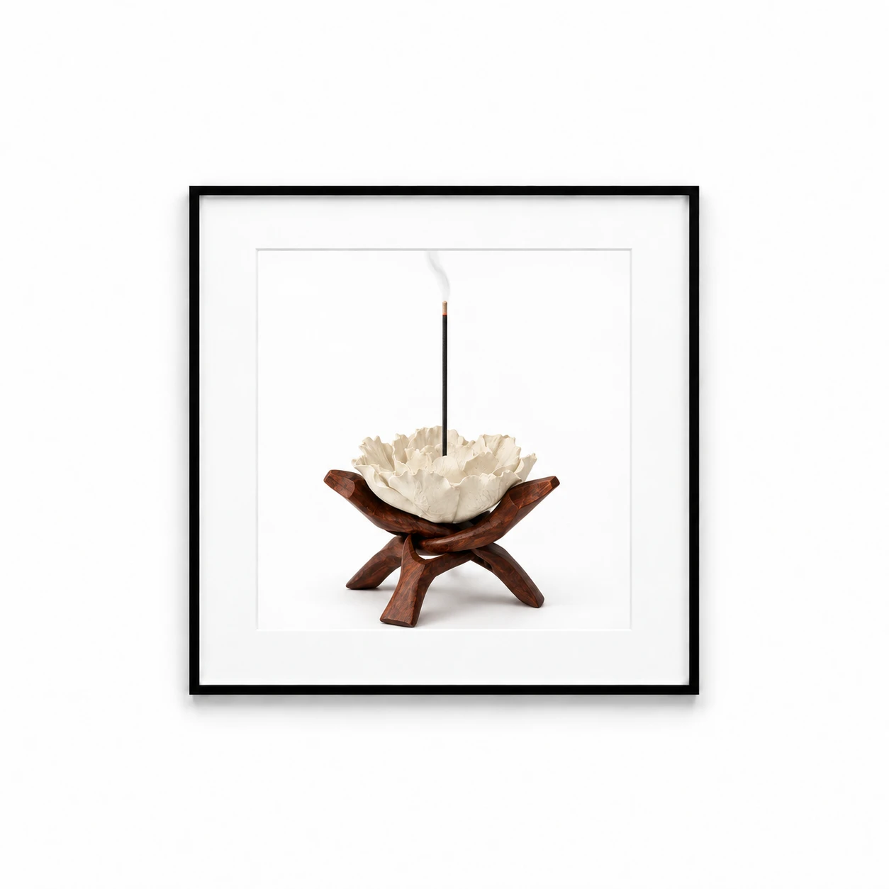White porcelain flower incense holder displayed in a black gallery frame